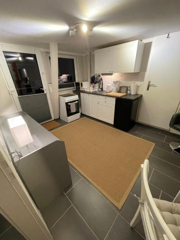 a kitchen with white cabinets and a counter top at Ferienwohnungen Waldkauz in Kröppelshagen-Fahrendorf