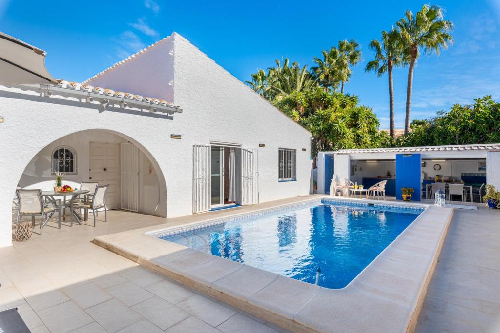 a villa with a swimming pool and a house at Villa Anais - PlusHolidays in Calpe