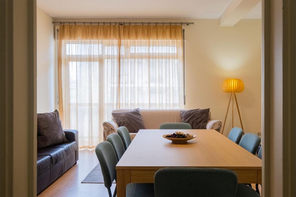 a living room with a table and chairs at 53 Urban Place in Ponta Delgada