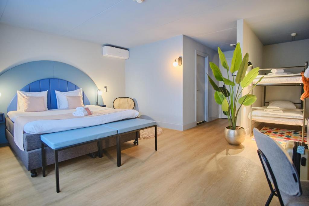 a bedroom with a bed and a bench in a room at Hotel Halbert in Groningen