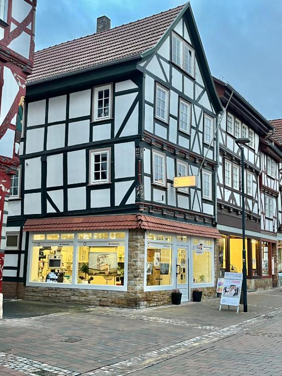 a black and white building on a street at Ferienwohnungen am Markt - historischer Marktplatz im Herzen der Altstadt in Eschwege