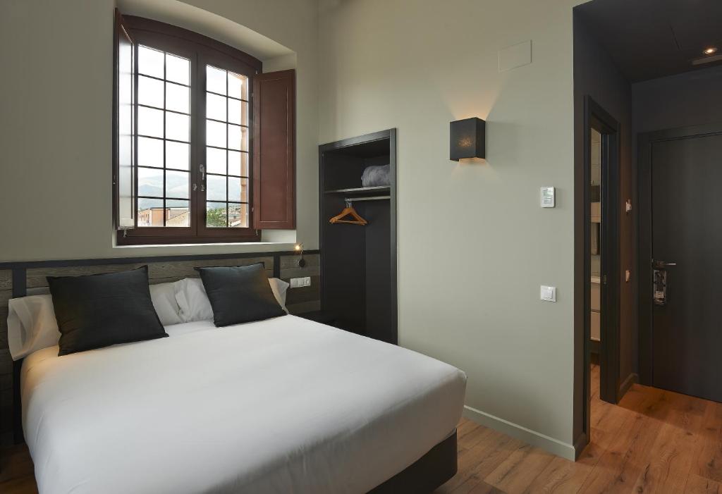 Postel nebo postele na pokoji v ubytování Hotel Parada Puigcerda