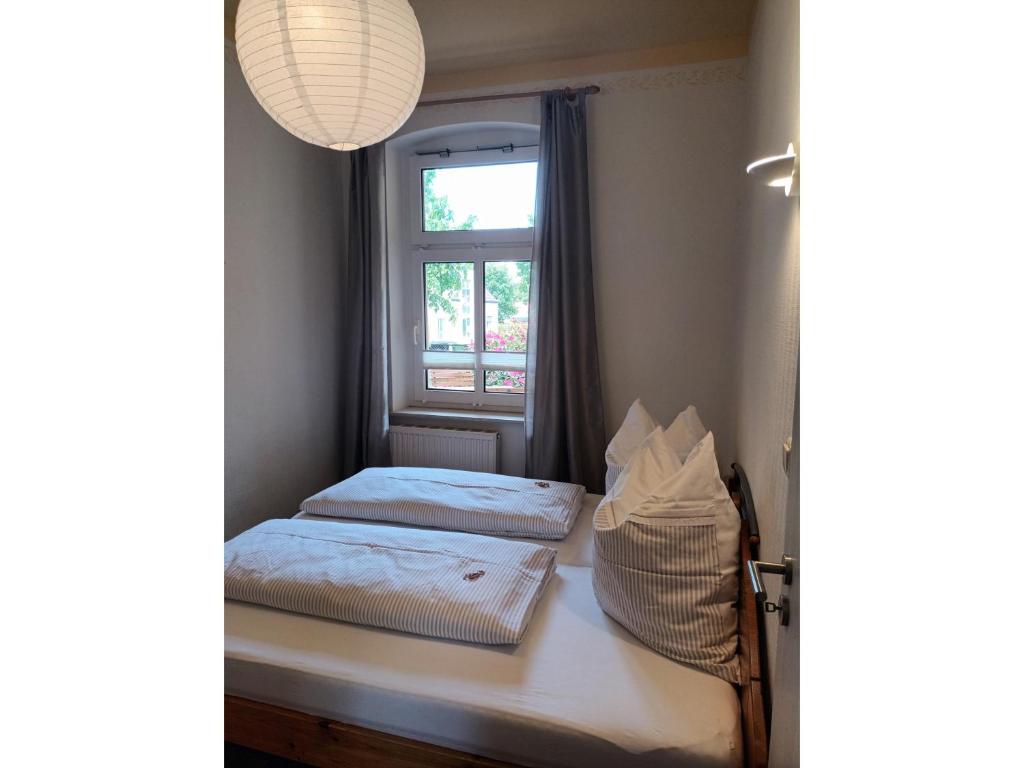 a bedroom with two beds and a window at KOS - Haus Netti in Koserow