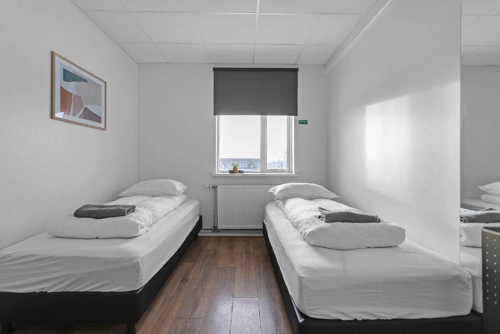 Postel nebo postele na pokoji v ubytování Bank Guesthouse by KEF Airport