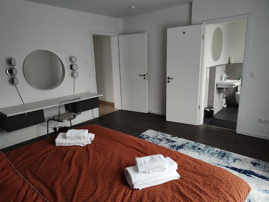 a bedroom with a bed with two towels on it at Hotel Valley of Business Frankfurt-Airport - GREY LABEL PENTHOUSE in Hofheim am Taunus