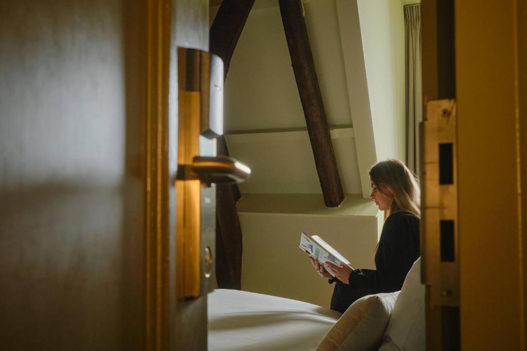 Postel nebo postele na pokoji v ubytování Hotel Corps de Garde