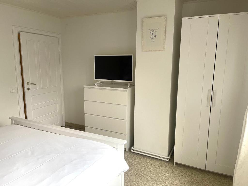 a bedroom with a bed and a flat screen tv at The Nest in Sinaia
