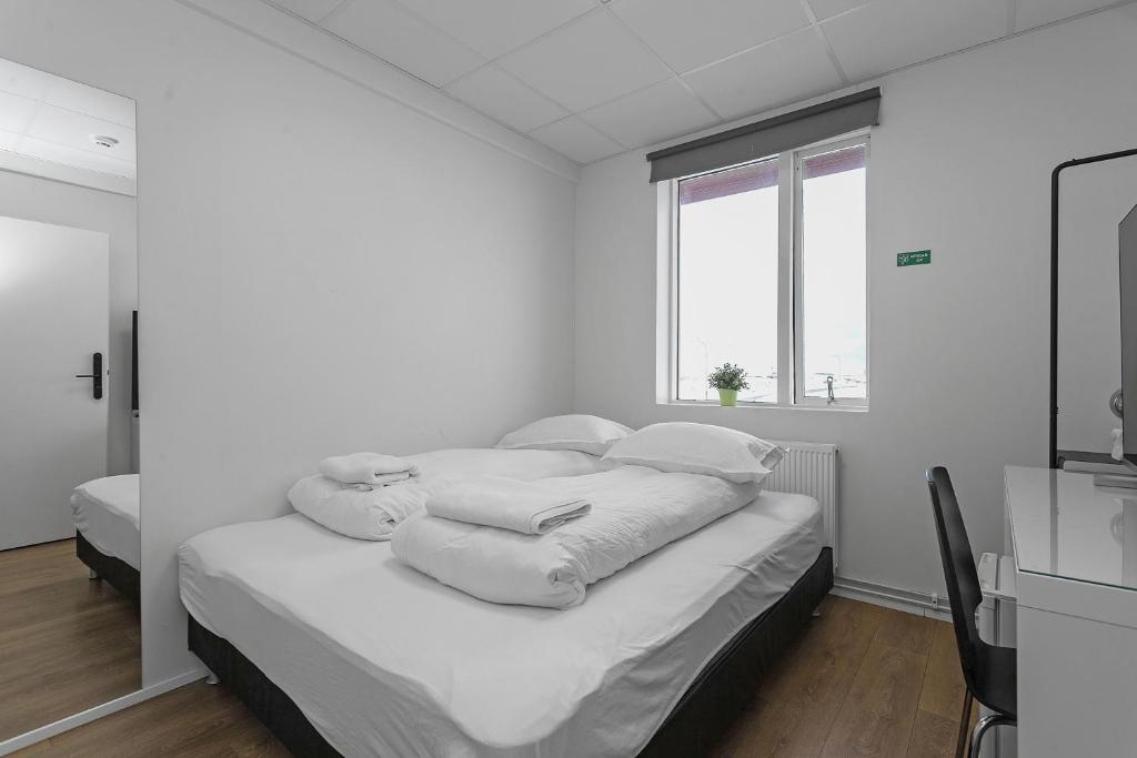 Postel nebo postele na pokoji v ubytování Bank Guesthouse by KEF Airport