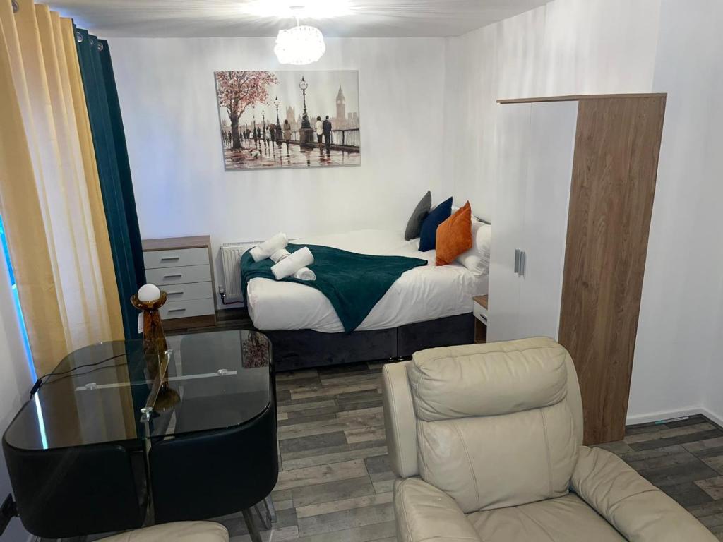 a bedroom with a bed and a table and a chair at Private Room in London Enfield with parking in Enfield