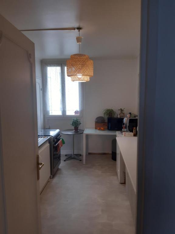 Zimmer mit einer Küche mit einem Tisch und einem Fenster in der Unterkunft Apparemment 2 chambres in Fontenay-le-Fleury