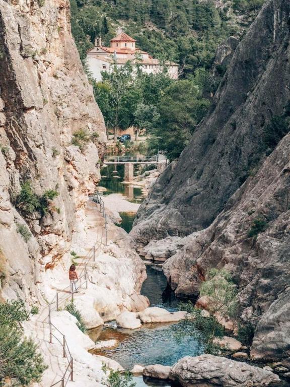 a person standing next to a river in a canyon at Paros in Tarragona