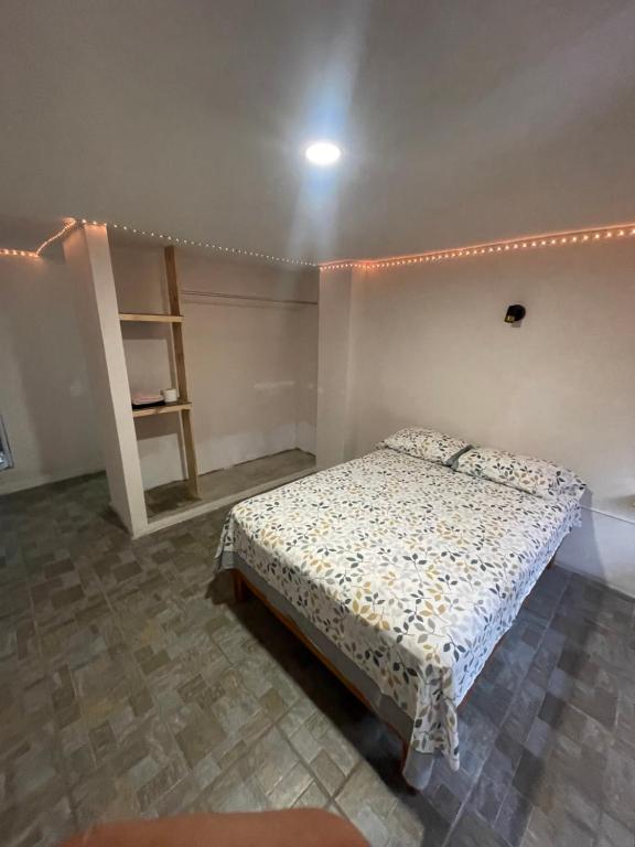 a small bedroom with a bed and a shelf at Laguna 11 in Tampico