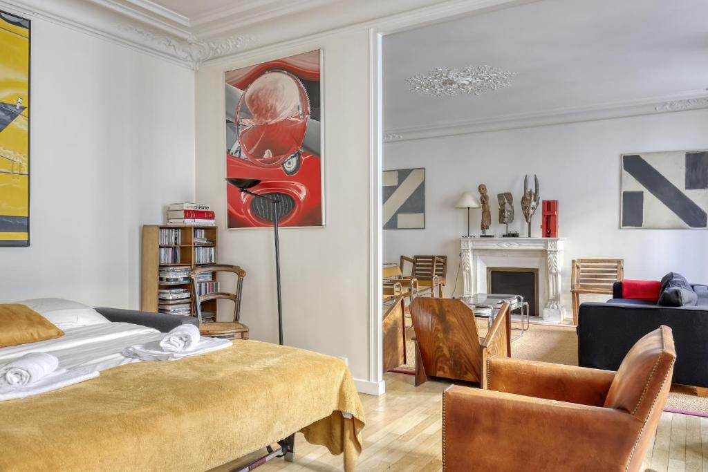 a bedroom with a bed and a living room at Gorgeous and large flat in the heart of Paris 09 in Paris