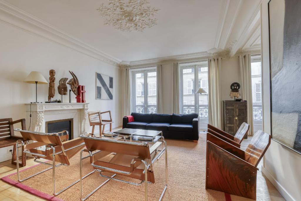 a living room with a couch and a table at Gorgeous and large flat in the heart of Paris 09 in Paris