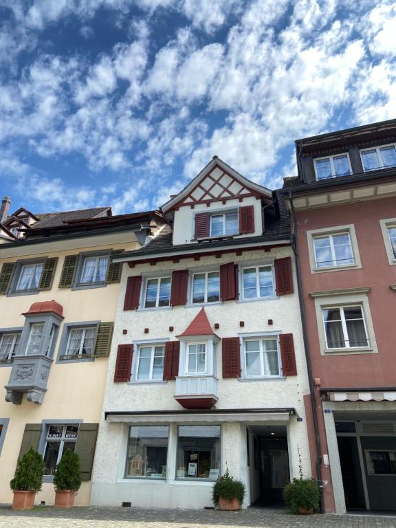 een hoog gebouw met ramen en een blauwe lucht bij Understadt 14 guesthouse in Stein am Rhein