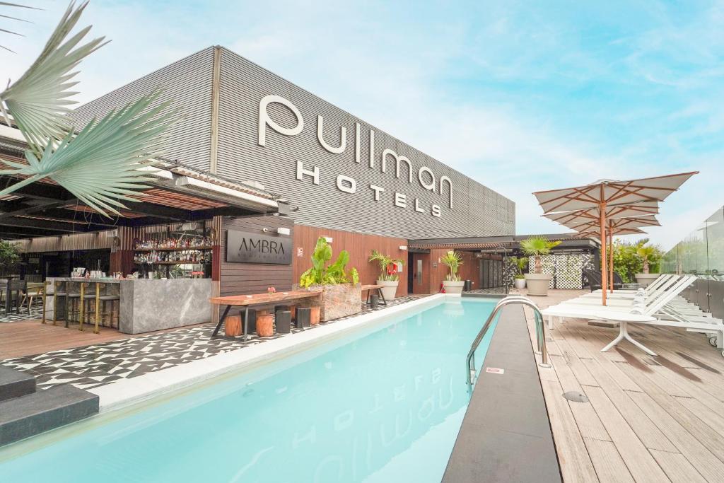 a swimming pool in front of a hotel at Pullman Lima Miraflores in Lima