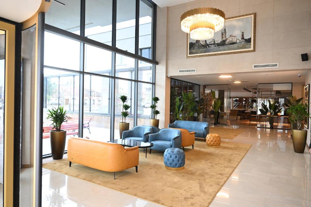 a lobby with couches and chairs in a building at Hotel Tamiš & Spa in Pančevo