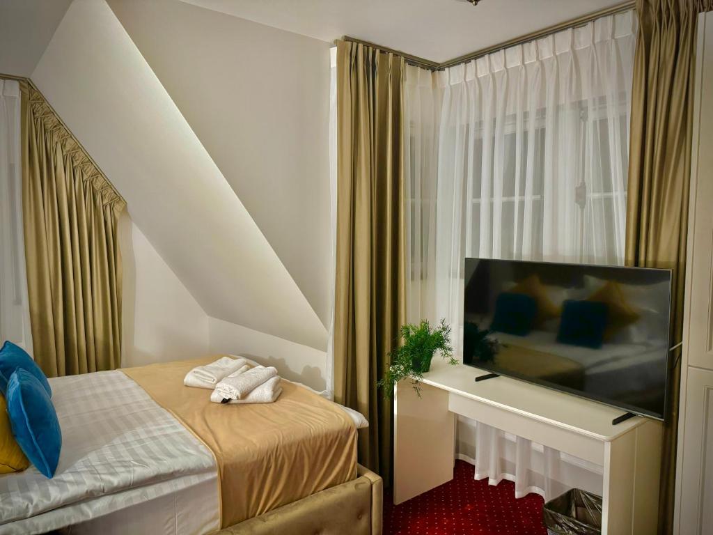 Postel nebo postele na pokoji v ubytování Vila Șipot - Casa Arhitecților