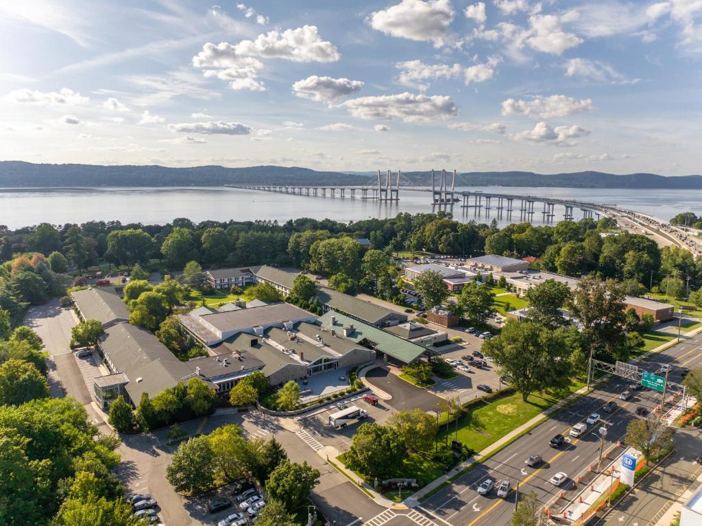 an aerial view of a parking lot with a bridge in the background at Sleepy Hollow Hotel in Tarrytown