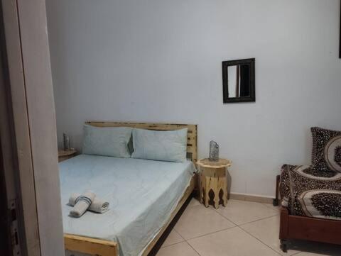 a bedroom with a bed with two slippers on it at Dar El jadida in El Jadida