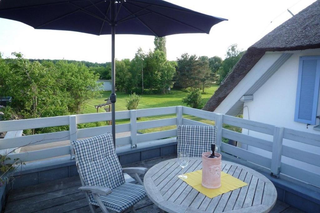 a table and two chairs with an umbrella on a patio at Appartement "Romantika" in Klink