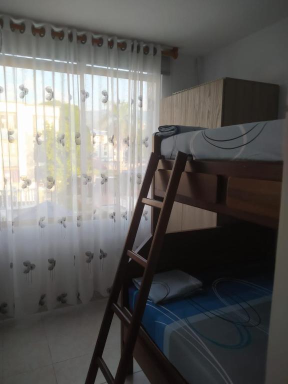 Postel nebo postele na pokoji v ubytování Malecón del Sumapaz