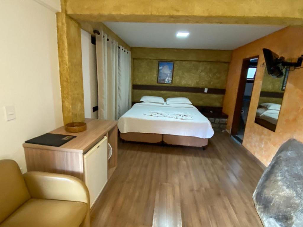 En eller flere senge i et værelse på Pousada Peterle