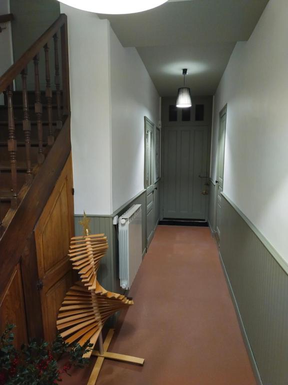 a hallway with a staircase and a wooden bench at Les Balcons sur la Loire in Chalonnes-sur-Loire