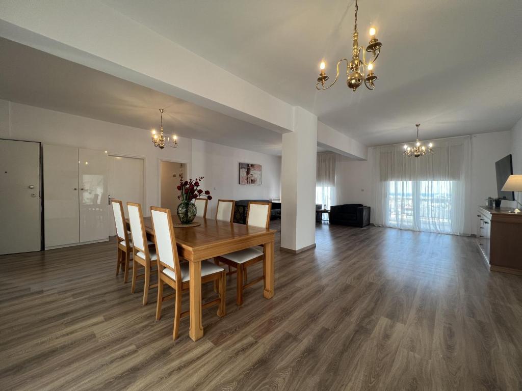 a dining room and living room with a table and chairs at Sunny Rooms in Limassol