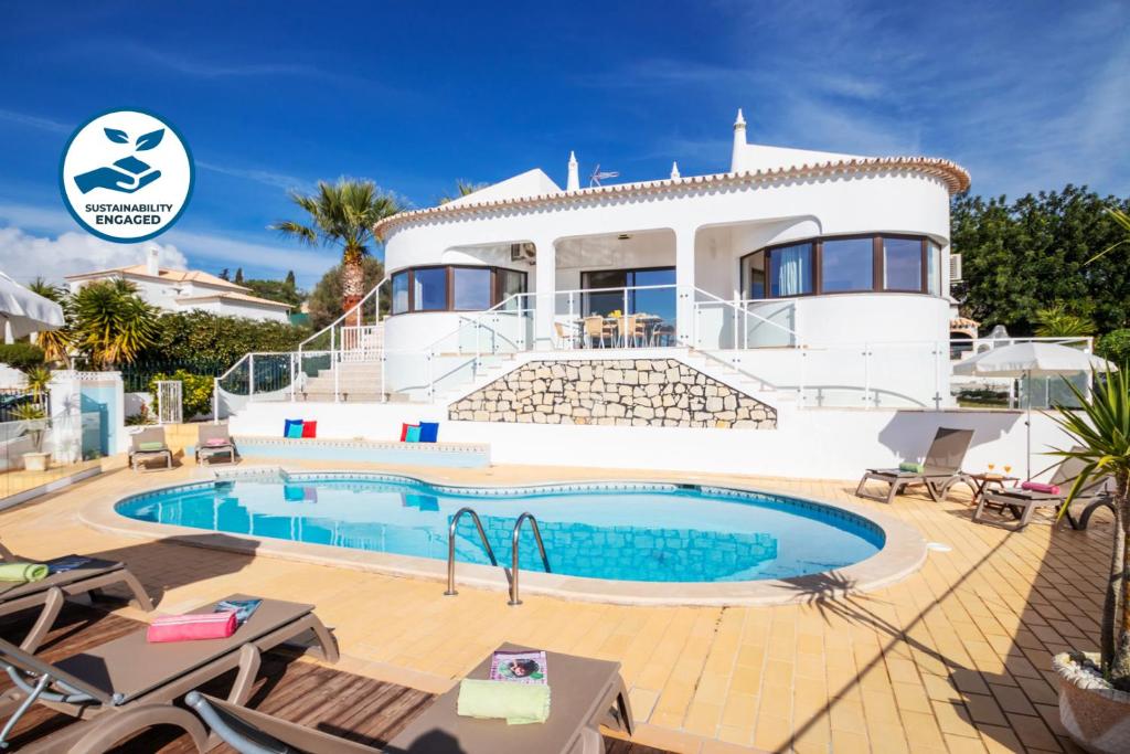 a house with a swimming pool in front of it at Villa Saint John by Algarve Vacation in Albufeira