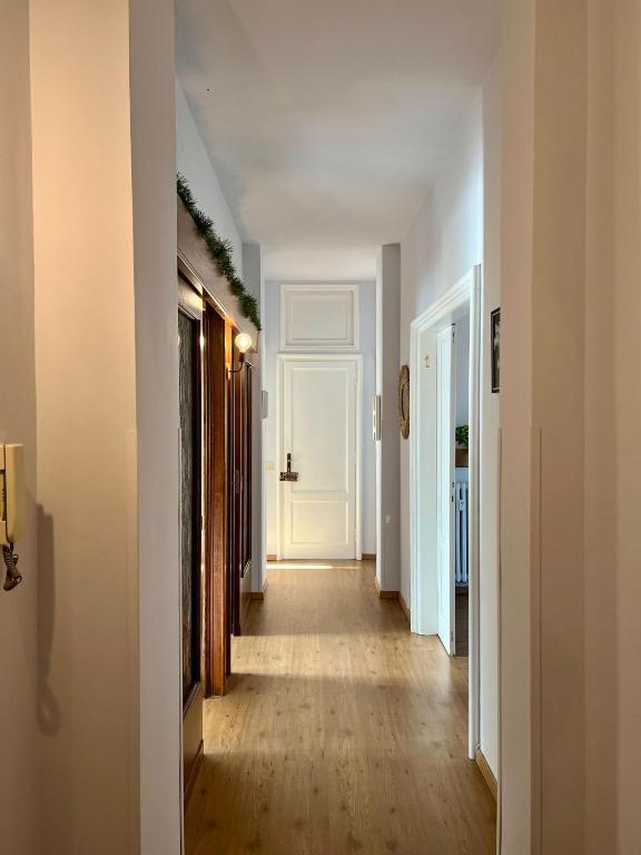 a hallway with white walls and wooden floors at Flaminio Luxury Home - City Center in Rome