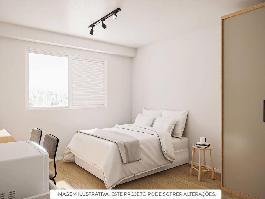 a white bedroom with a bed and a window at Apt. inteiro recém-reformado - Vila Clementino in Sao Paulo