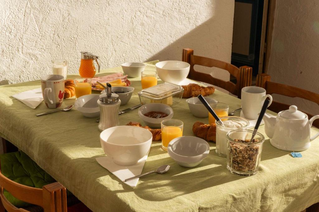 a table with breakfast foods and drinks on it at Les Balcons sur la Loire in Chalonnes-sur-Loire