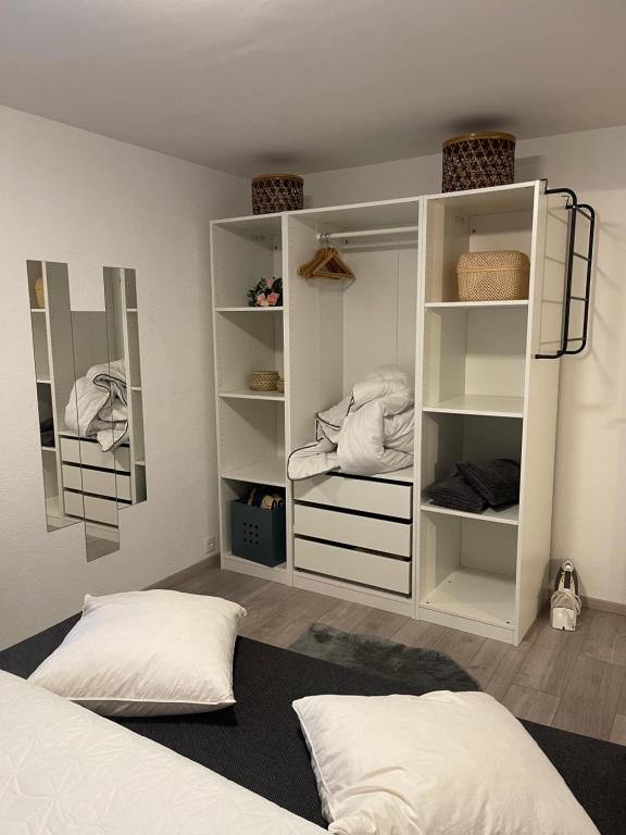 a bedroom with white shelves and a bed at Tina in Villeneuve