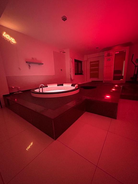 a red room with a tub in the middle of a bathroom at SAN NICOLA LUXURY in Bari