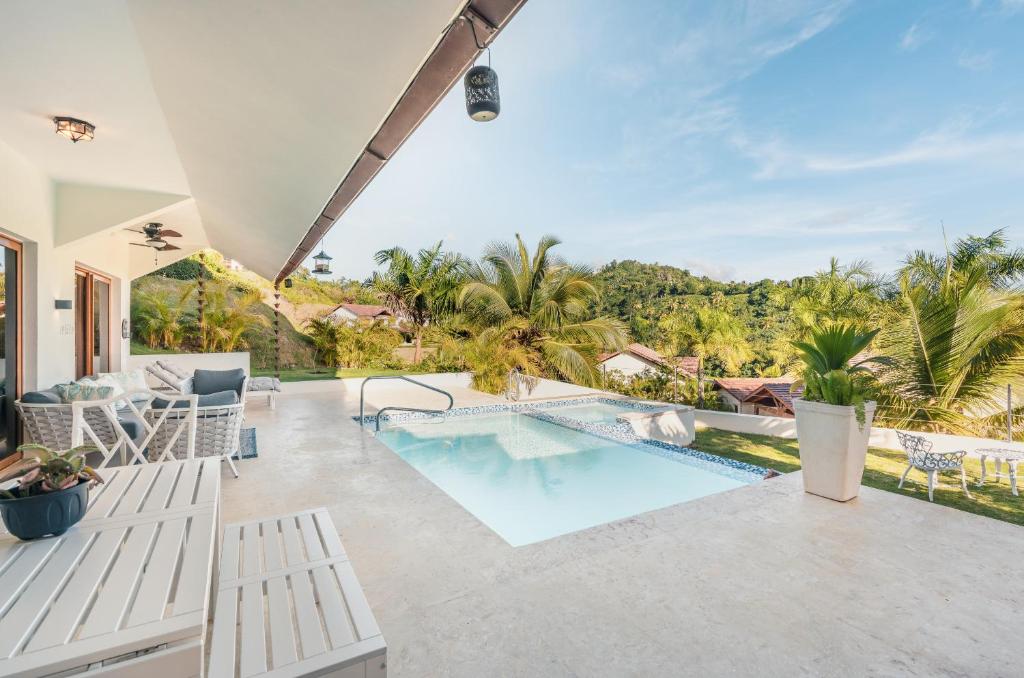 an outdoor patio with a swimming pool and a resort at SPECIAL PRICE Puerto Bahia 3BR Villa in Santa Bárbara de Samaná