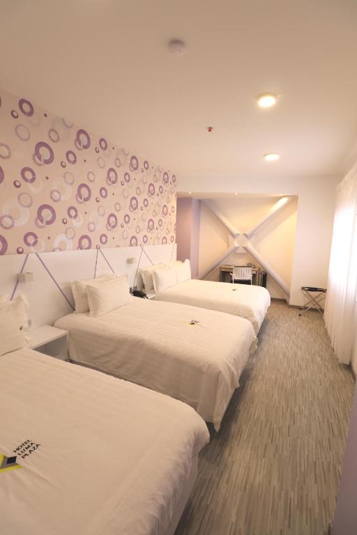 Postel nebo postele na pokoji v ubytování Luma Plaza Hotel