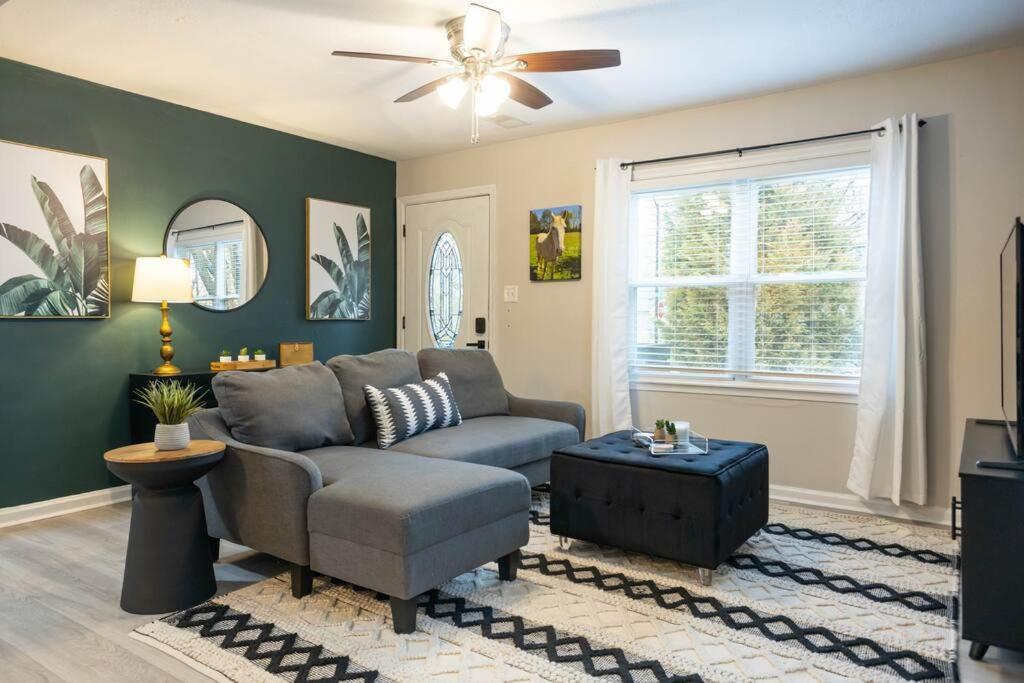 a living room with a couch and a ceiling fan at Bluegrass Bungalow in Louisville