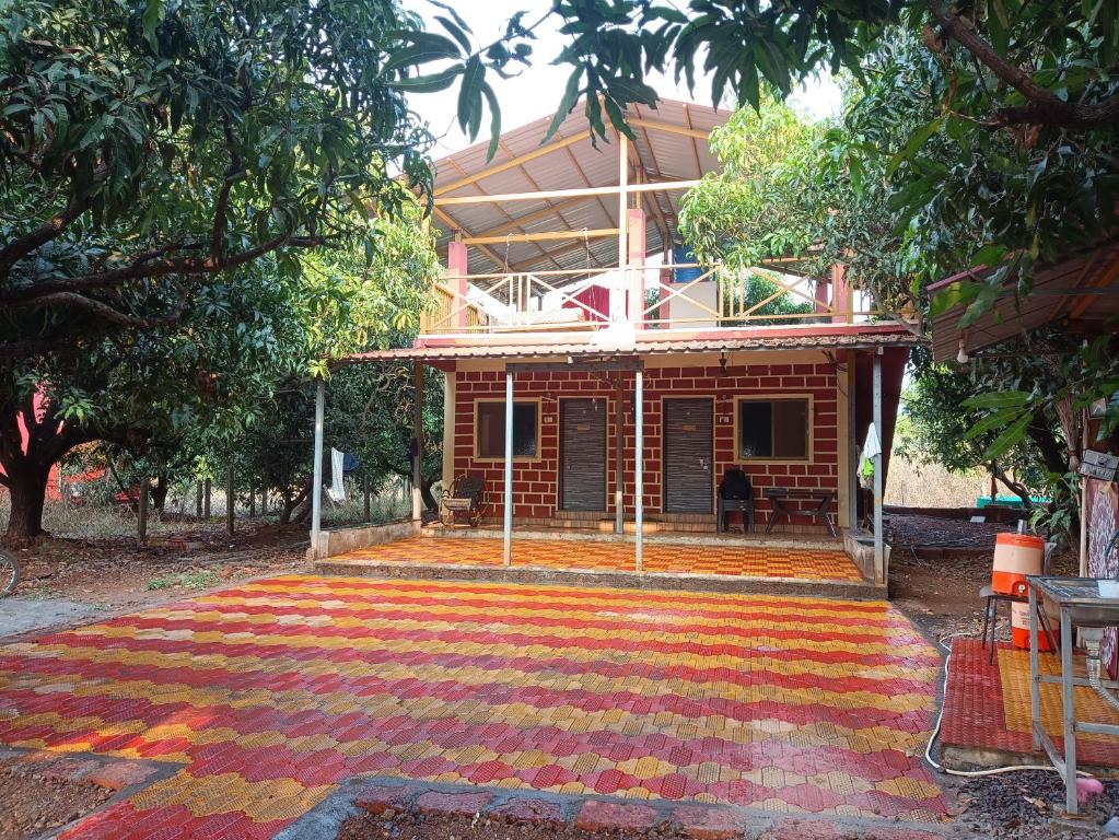a house with a colorful rug in front of it at Gazebo Holiday Home in Srīvardhan