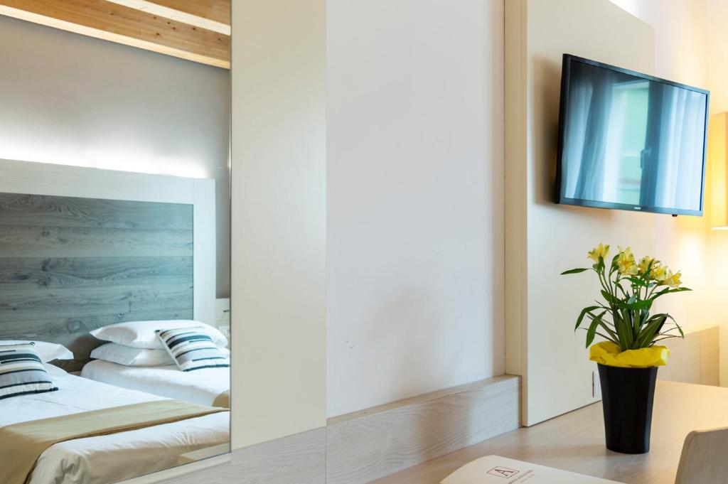Postel nebo postele na pokoji v ubytování Hotel Alexander