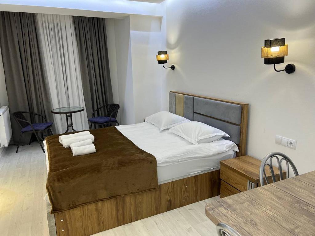 a bedroom with a bed with two towels on it at Hotel Peak in Gudauri