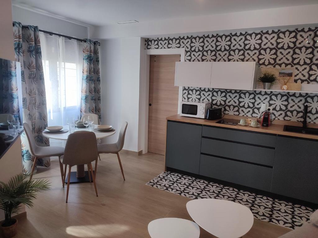 a kitchen and dining room with a table and a dining room at La Noguera Rural Suite in Güéjar-Sierra