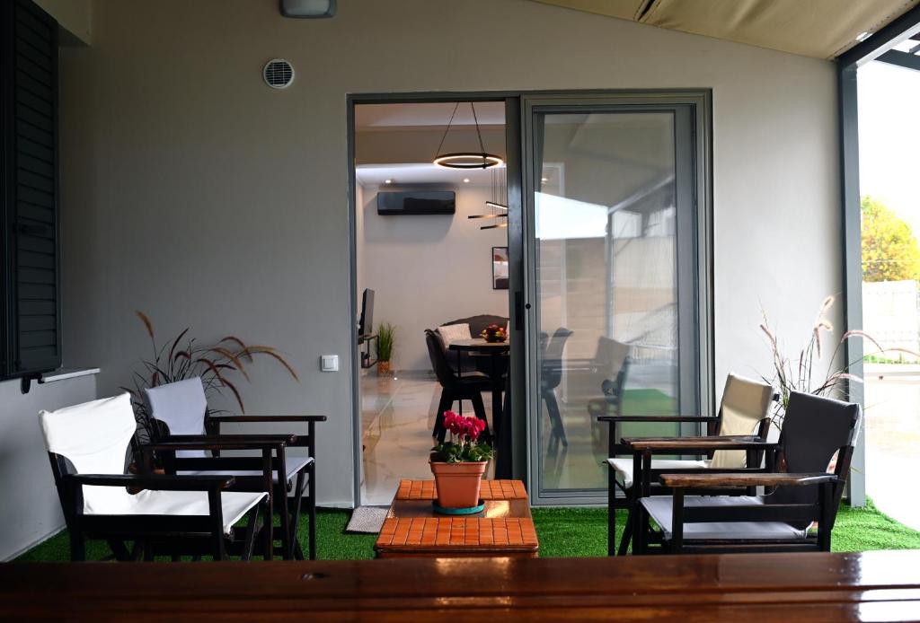 a patio with chairs and a table and a table at Aura House in Koutsopódhion