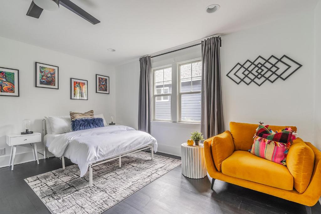 a bedroom with a bed and a couch and a window at Capitol Hill Cutie in Seattle