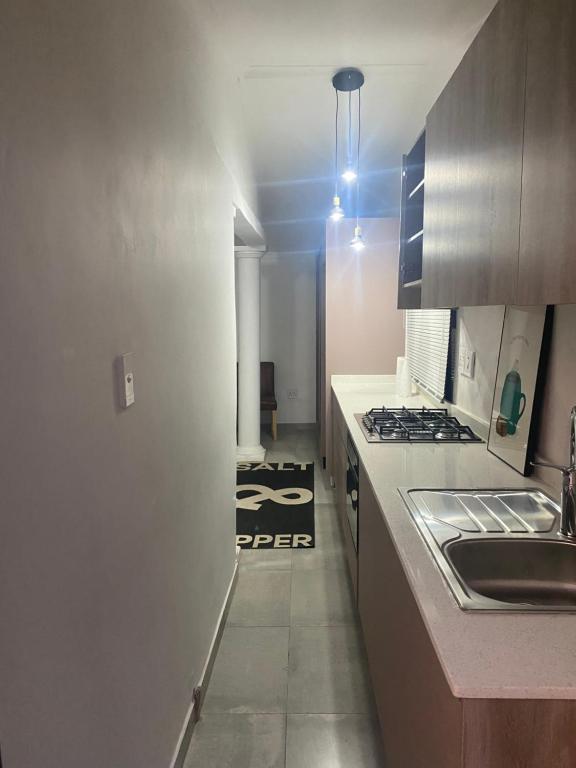 a kitchen with a sink and a stove at Studio house in Durban