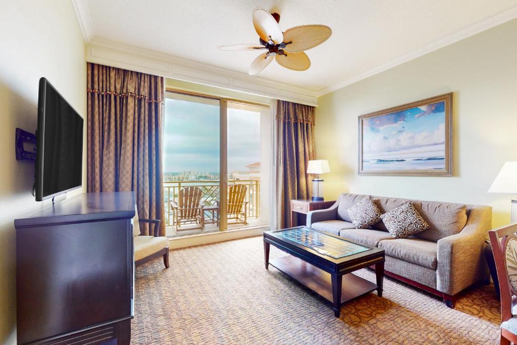 a living room with a couch and a tv at Sandpearl unit 757 in Clearwater Beach