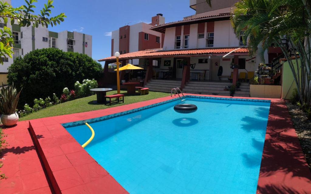 a swimming pool in front of a house at Point do Rio Vermelho in Salvador