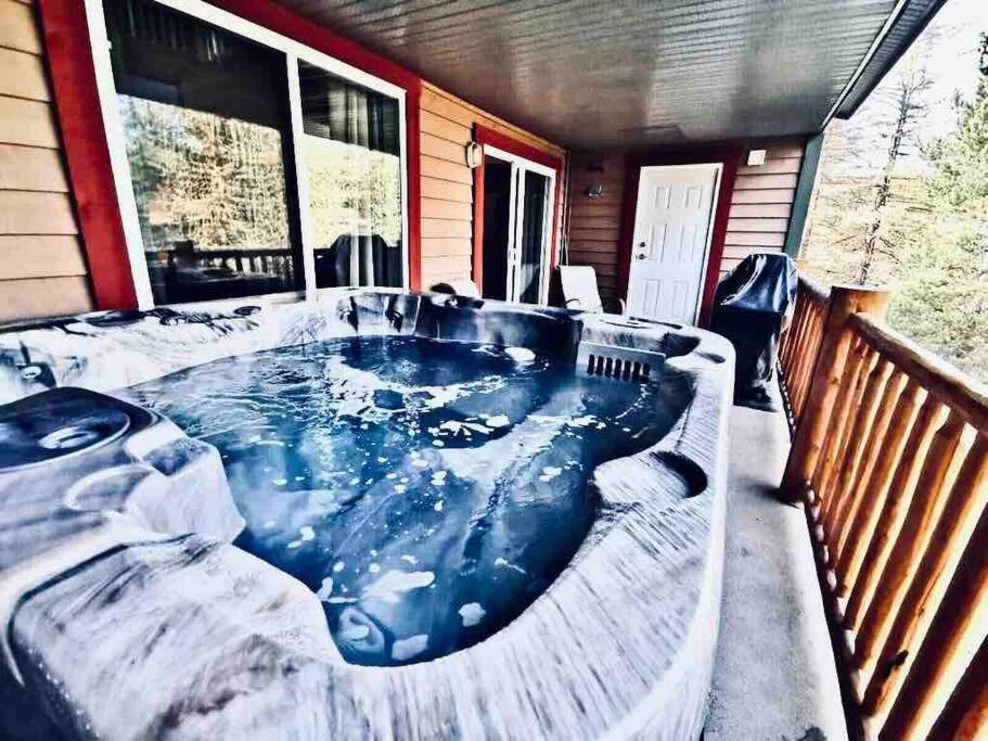 a jacuzzi tub on the back of a house at Cozy updated 3 BDRM/3 BTH on ski hill with private hottub (110) in Kimberley