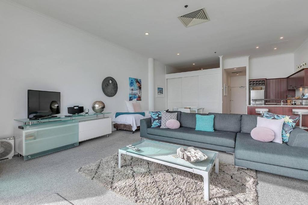 a living room with a couch and a table at AWSA On the Water Luxury (4003) in Auckland