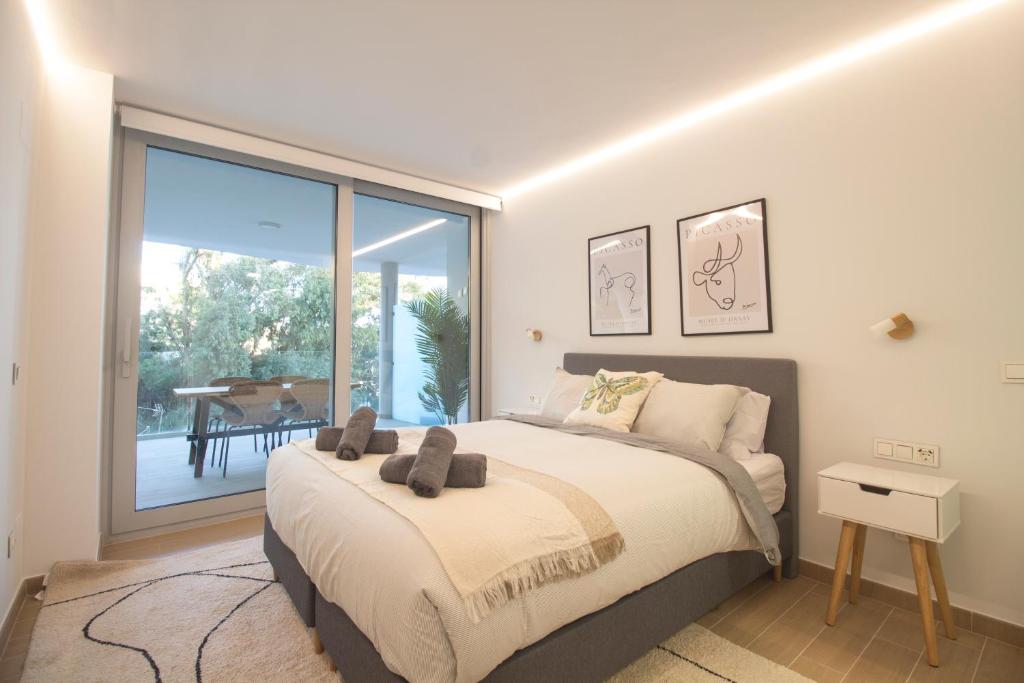 a bedroom with a bed and a large window at Sea View Apartment Near The Beach in Fuengirola